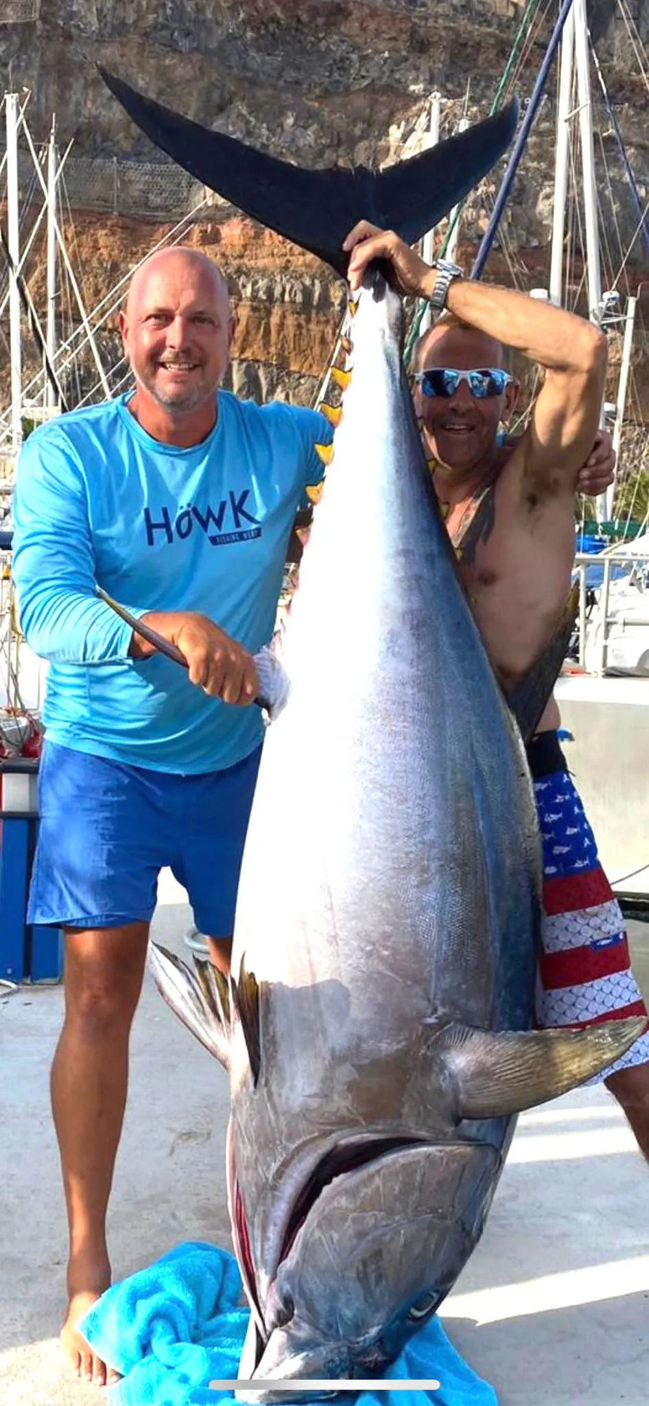 A giant tuna landed off South Tenerife Angler holding a giant tuna by the tail after a Mikestrike charter, Tenerife