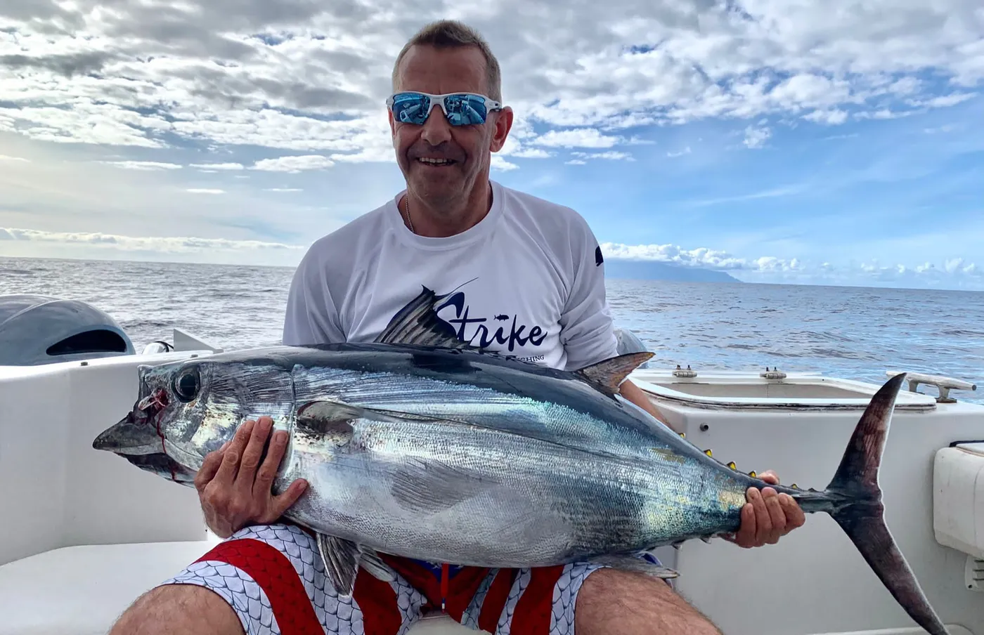 Tuna caught on the South Tenerife coast Angler with a tuna on the South Tenerife coast after a fishing charter