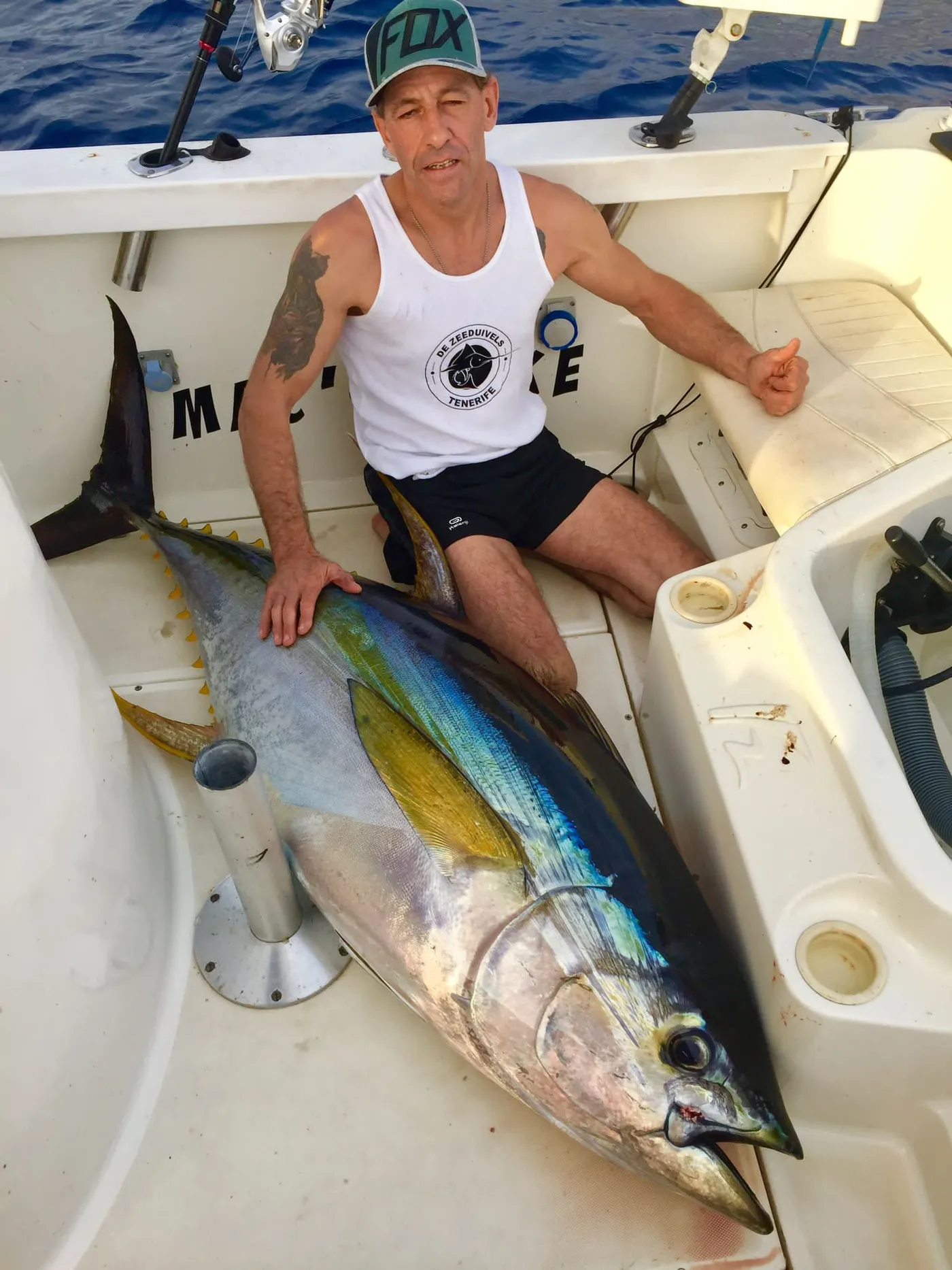 An angler holding a yellowfin tuna caught aboard Mikestrike off Tenerife
