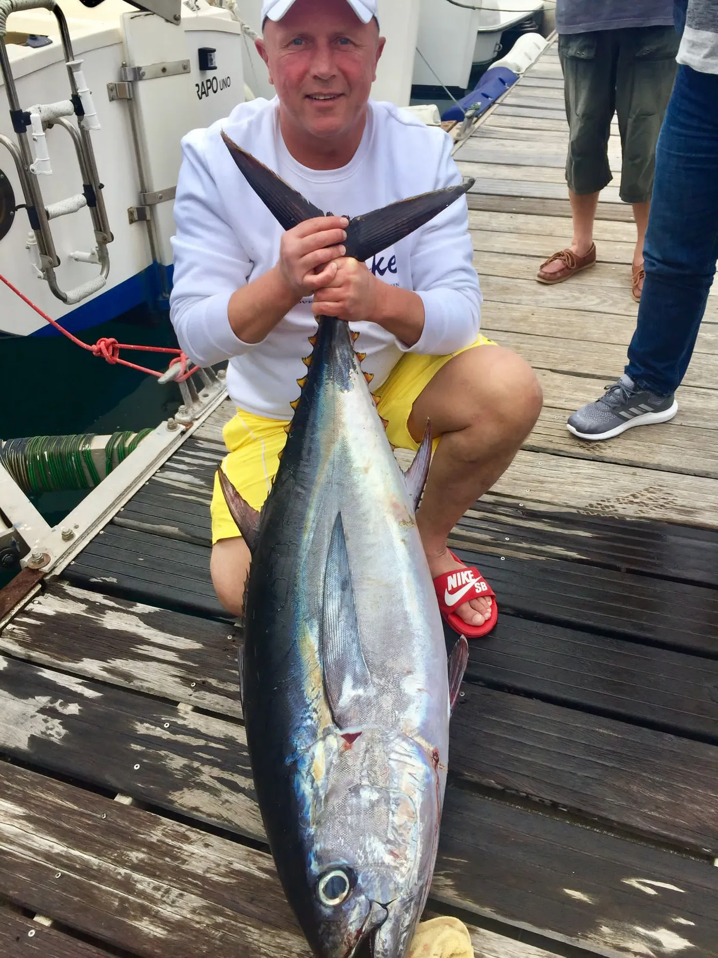 Yellowfin tuna landed off Tenerife Angler kneeling with a yellowfin tuna caught aboard Mikestrike, Tenerife