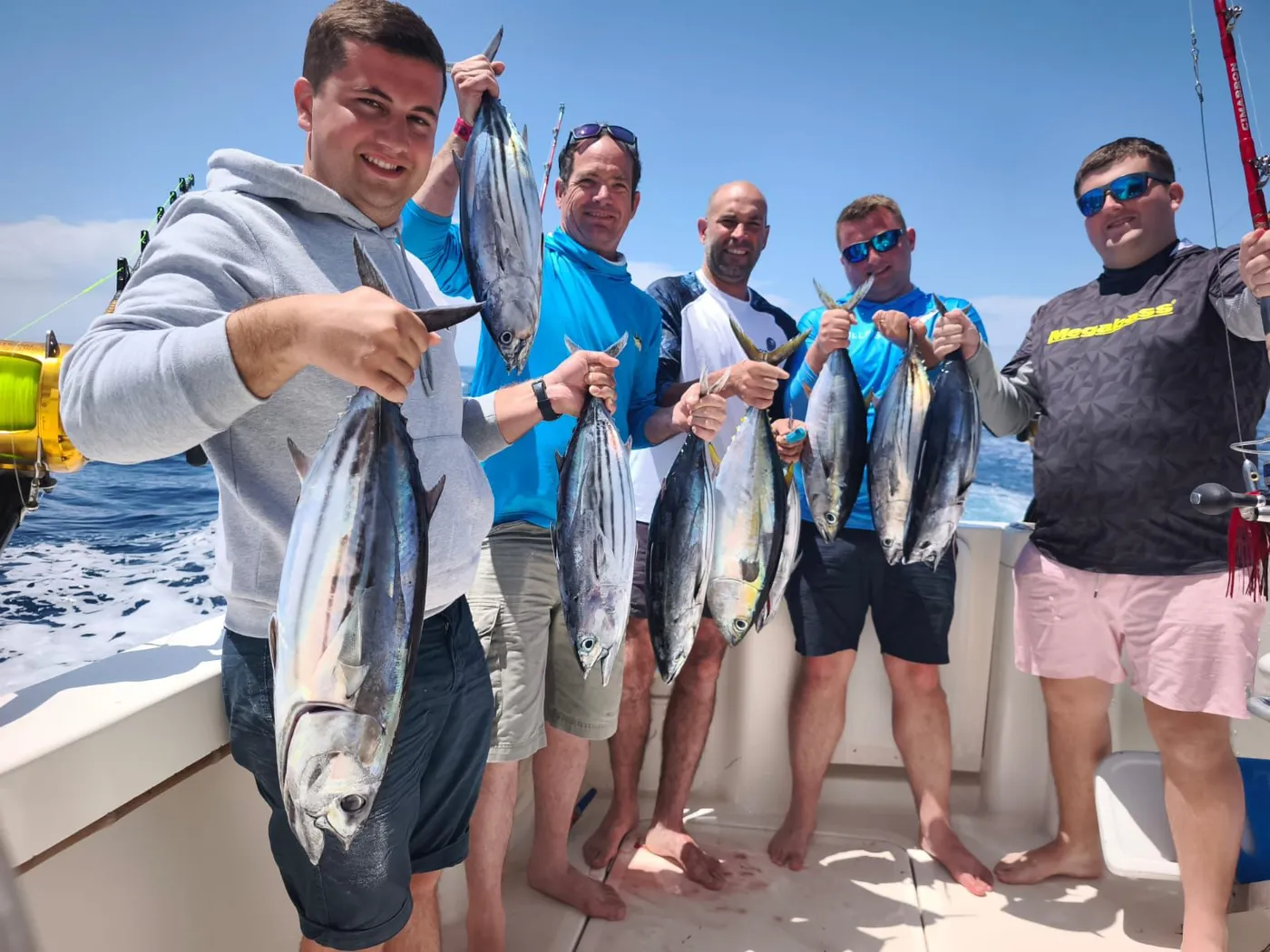 Anglers sharing a No Limits One trip with their tuna catch off South Tenerife
