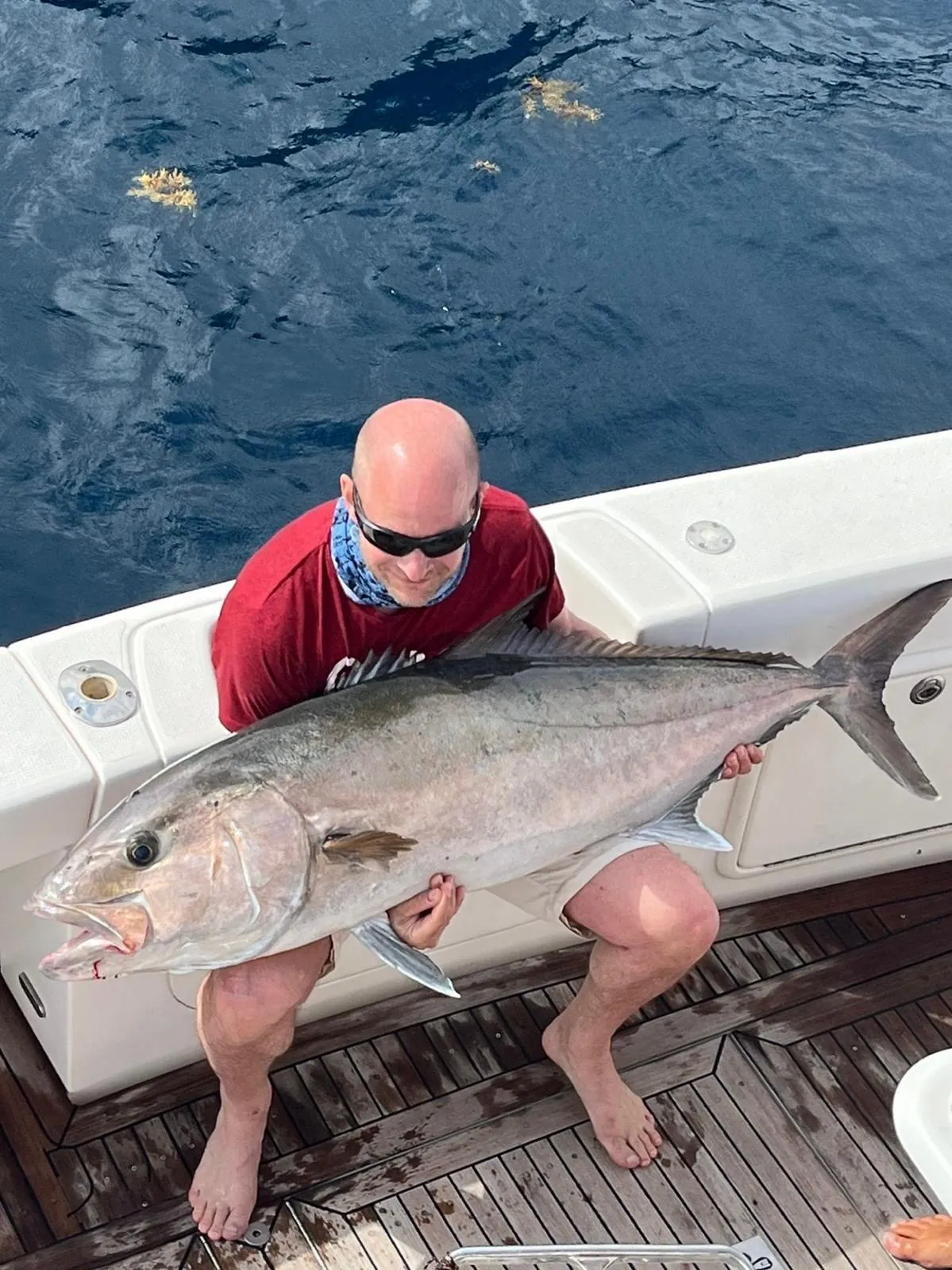 A large amberjack aboard the Tanoa Angler holding a large amberjack on the teak deck of the Tanoa, Tenerife