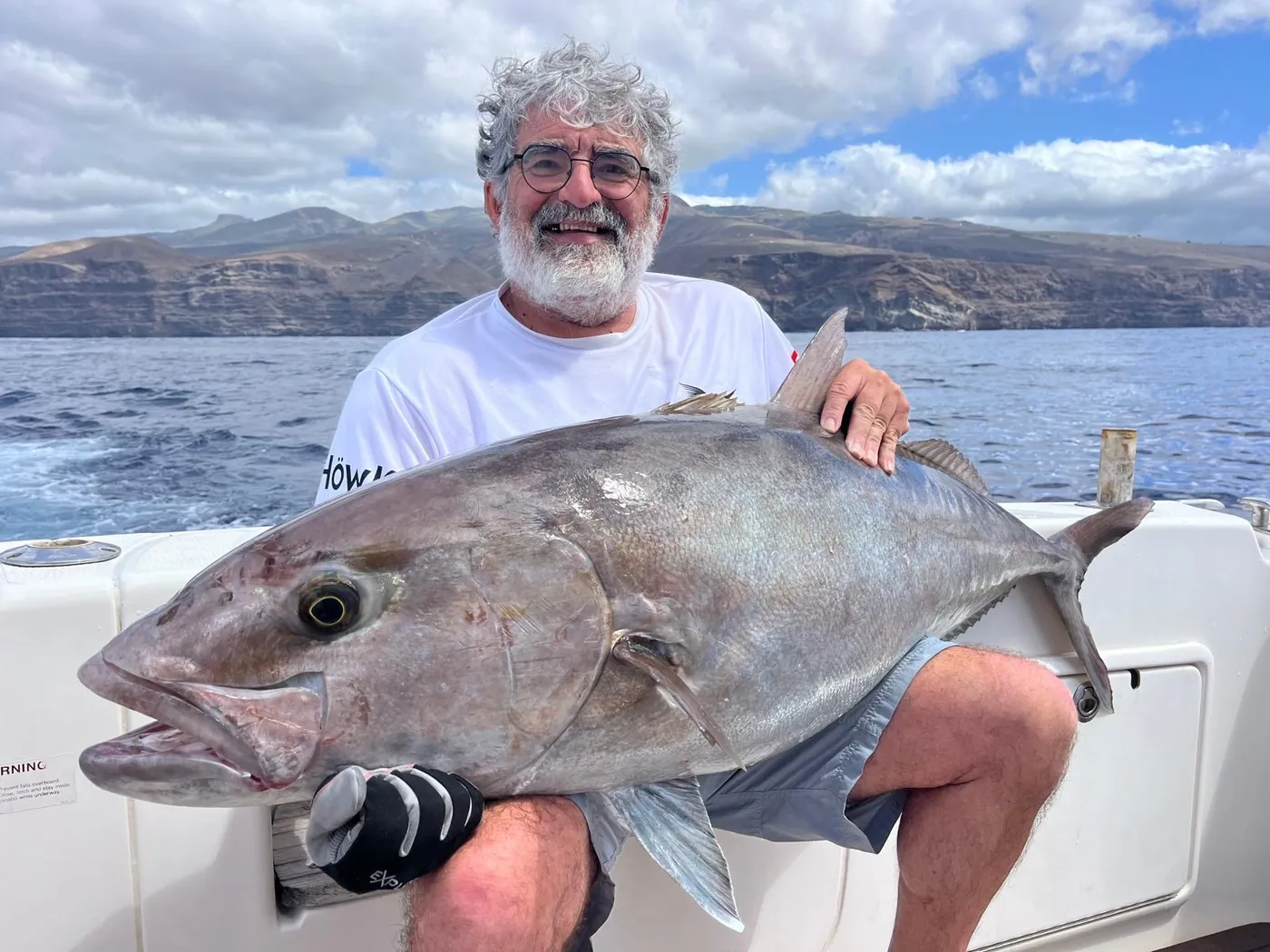 A giant amberjack aboard the Tanoa Angler holding a giant amberjack caught aboard the Tanoa off Tenerife